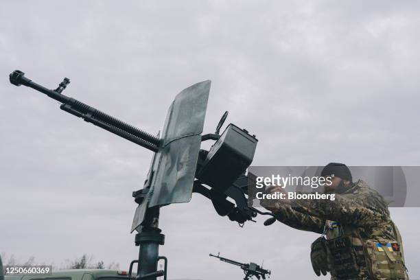Ukrainian soldier demonstrates a truck-mounted DShK machine gun during a handover of mobile anti-aircraft pick-up trucks by Herocar, as part of the...