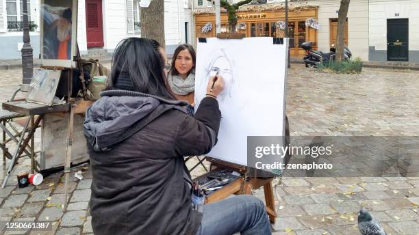 drawing a portrait at place du tertre paris - art du portrait stock pictures, royalty-free photos & images