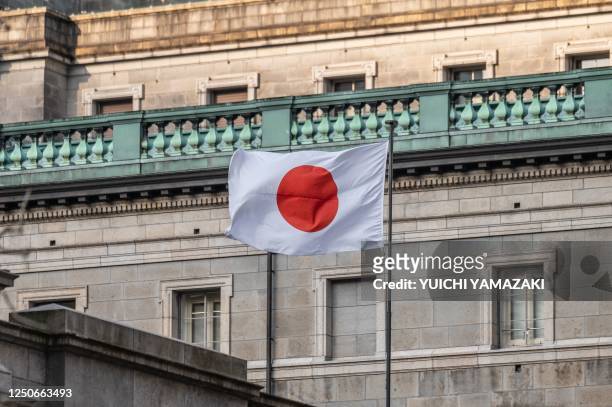 The Japanese national flag is seen at the Bank of Japan headquarters in Tokyo on April 3, 2023.