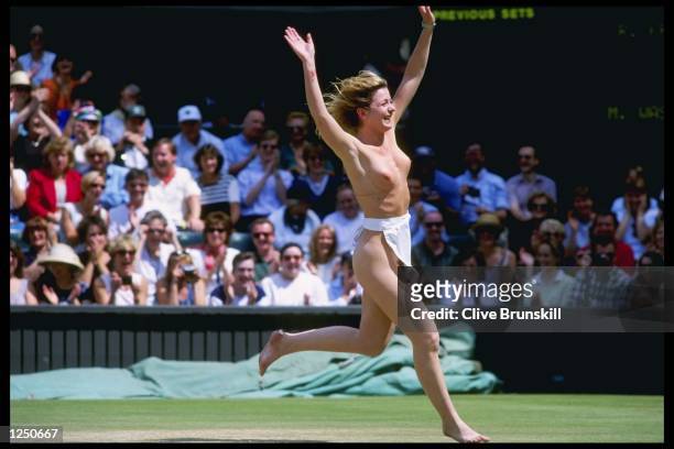 Streaker entertains the crowd before the start of the mens final during the Wimbledon tennis championships at the all England Club in London,...