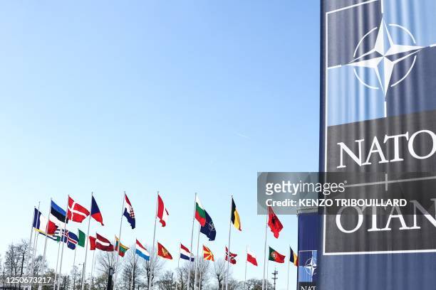 The national flags of countries member of the NATO fly outside the organisation headquarters in Brussels on April 3, 2023.