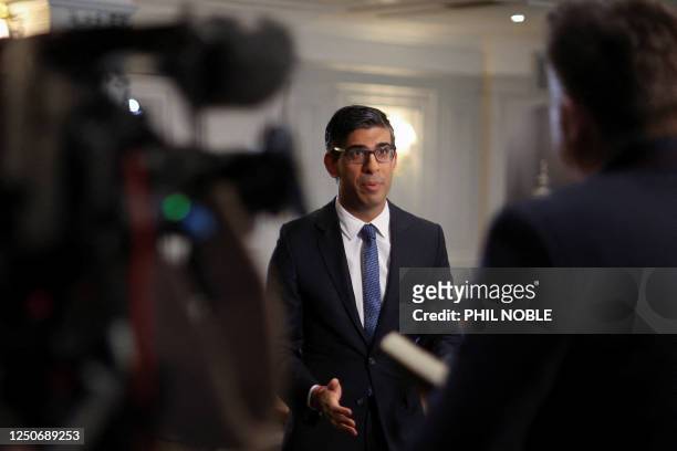 Britain's Prime Minister Rishi Sunak gives an interview to broadcast tv media, following a meeting with local community and police leaders, after the...