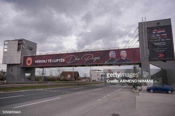 Giant banner depicting former Kosovan president Hashim Thaci and former parliament speaker Kadri Veseli is displayed in Pristina on April 3, 2023. -...