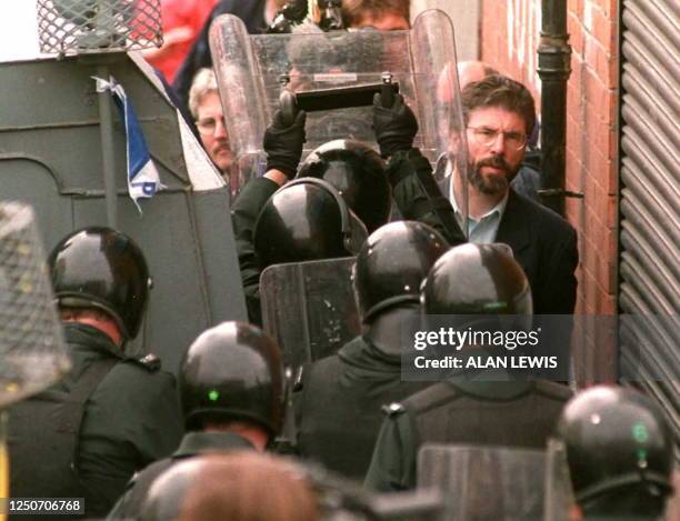 Sinn Fein President Gerry Adams is held back behind police as Protestant Orangemen parade passes through the Lower Ormeau road area of Belfast 12...