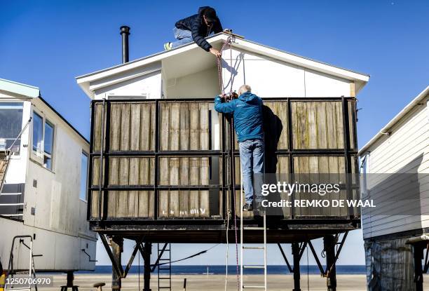 Photograph taken on April 3, 2023 shows beach houses being reinstalled for the summer season on the beach in IJmuiden, The Netherlands. / Netherlands...