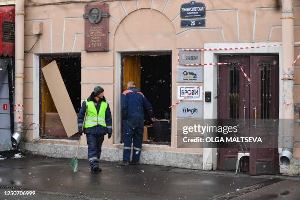 Municipal workers clean the debris in the aftermath of the April 2 bomb blast in a cafe in Saint Petersburg on April 3, 2023. - Sunday's explosion in...