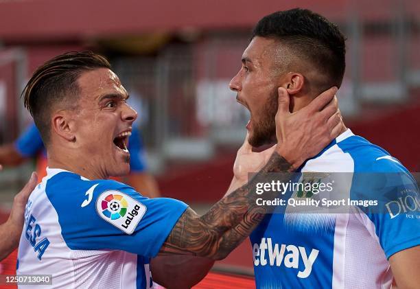 Oscar Rodriguez of Leganes celebrates after scoring his team's first goal with his teammate Roque Mesa during the Liga match between RCD Mallorca and...