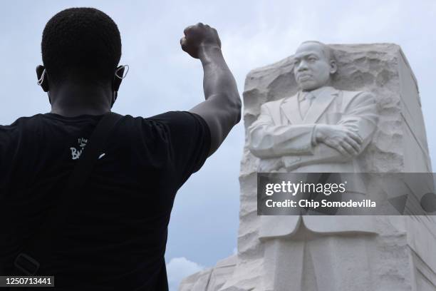 Man kneels and raises his fist in the air for eight minutes and 46 seconds -- the time that George Floyd was pinned under a police officer's knee --...