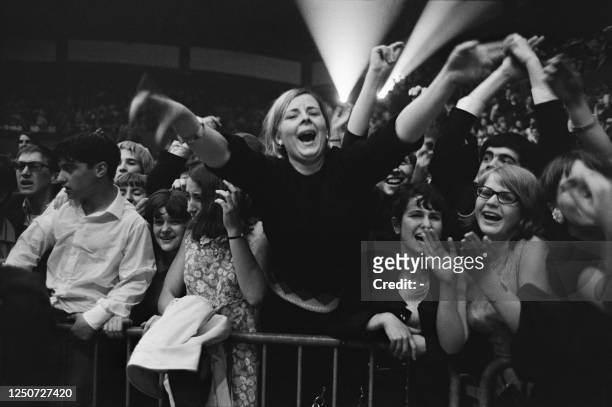 French fans wait for the Beatles before their concert at the Palais des Sports in Paris, on June 20, 1965. - British band The Beatles made two...