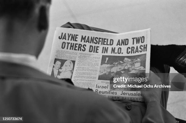 Man in New Orleans reads about the death of American actress Jayne Mansfield in a car crash outside the city the previous day, USA, 30th June 1967....