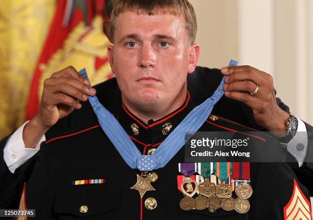 Former active duty Marine Corps Corporal Dakota Meyer is presented with the Medal of Honor by U.S. President Barack Obama during an East Room...