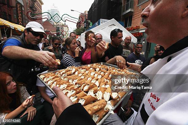 Free cannolis are passed out at the 85th annual Feast of San Gennaro festival September 15, 2011 in New York City. The annual Italian festival has...
