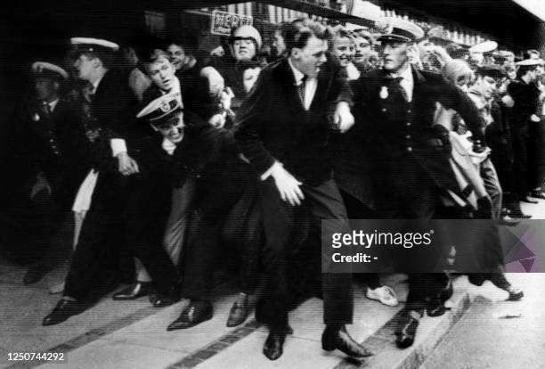 Danish policemen try to contain crowd of hysterical fans expecting the Beatles in front of the Royal hotel in Copenhagen, June 04, 1964. The Beatles...