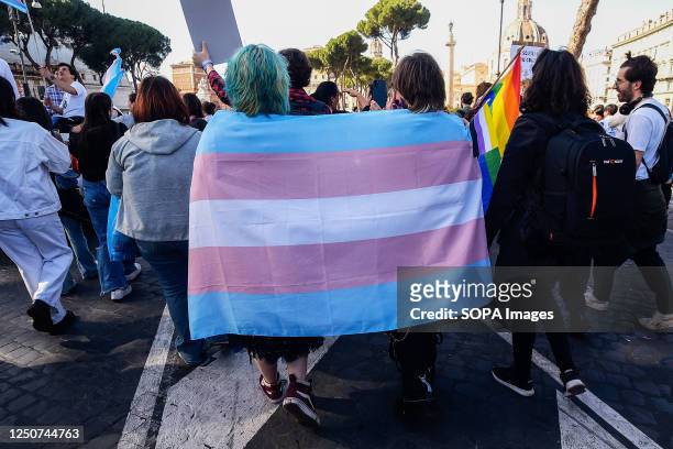 Two people wrapped in the transgender flag are seen during the Transgender Day of Visibility demonstration in Rome. The demonstration is part of the...