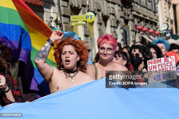 Topless protesters carry a giant transgender flag during Transgender Day of Visibility in Rome. The demonstration is part of the Transgender Day of...