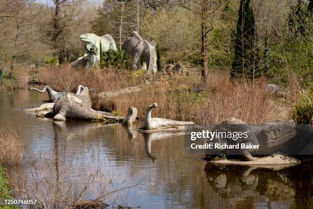 Park landscape of Victorian-era Grade I-listed dinosaur sculptures in Crystal Palace Park, on 3rd April 2023, in London, England. Crystal Palace Park...