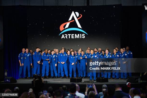 Current NASA astronauts stand on stage before a news conference held by NASA and CSA to announce the four astronauts who will venture around the...