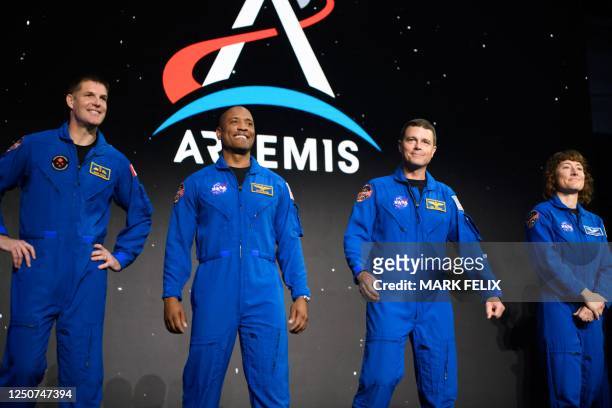 Astronauts Jeremy Hansen, Victor Glover, Reid Wiseman and Christina Hammock Koch stand onstage after being selected for the Artemis II mission who...