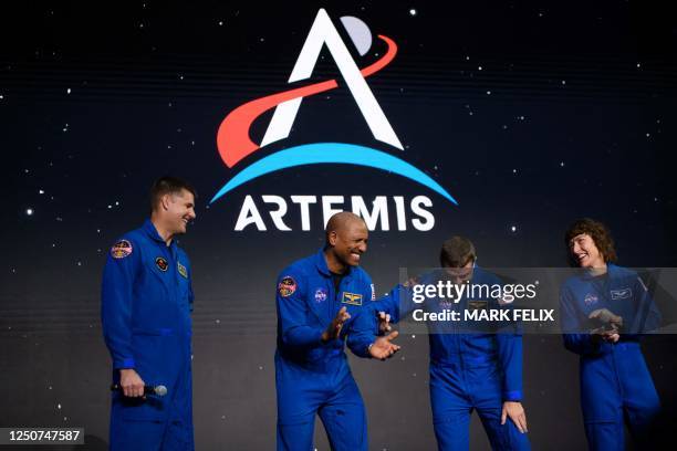 Astronauts Jeremy Hansen, Victor Glover, Reid Wiseman and Christina Hammock Koch celebrate after being selected for the Artemis II mission who will...