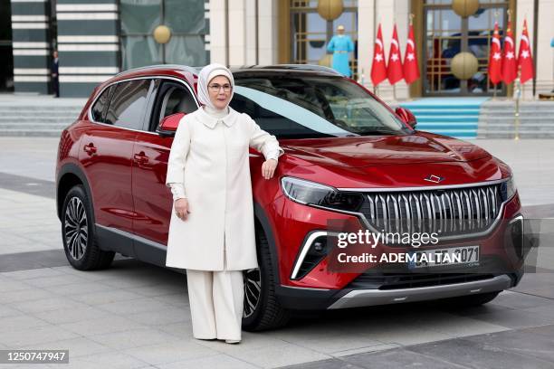 Wife of Tutish president, Emine Erdogan poses with her Togg T10X, Turkey's first domestically-produced electric car, after receiving it from the...