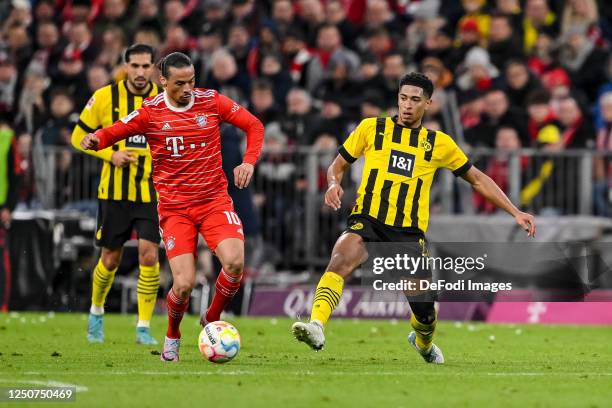 Leroy Sane of Bayern Muenchen and Jude Bellingham of Borussia Dortmund battle for the ball during the Bundesliga match between FC Bayern München and...