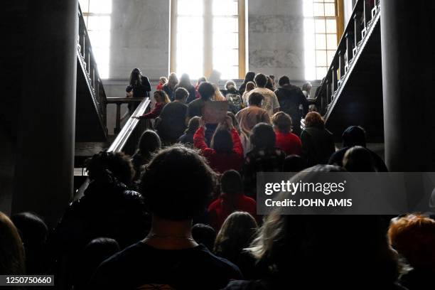 Protesting students make their way through the state Capitol building in Nashville, Tennessee, on April 3, 2023. - Students were encouraged by an...