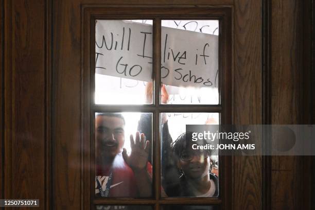 Student protesters hold up a sign as they wait to enter the State Capitol during anti-gun violence demonstration in Nashville, Tennessee, on April 3,...