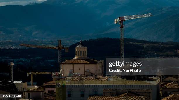 Drone view of the Chiesa di Sant'Agostino and cranes on the skyline of LAquila, Italy, on April 1, 2023 with crane . On April 6, the 14th anniversary...