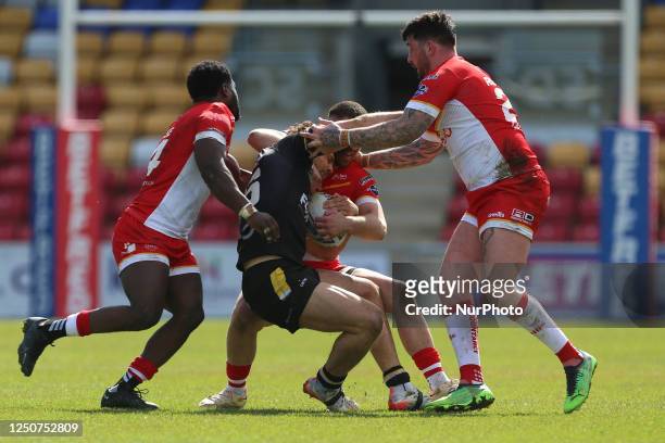 Sheffield Eagles' Vila HALAFIHI, Oliver ROBERTS and Titus GWAZE combine to tackle York Knights' BAILEY ANTROBUS during the Betfred Challenge Cup...