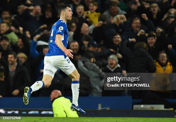 Everton's English defender Michael Keane celebrates after scoring his team first goal during the English Premier League football match between...