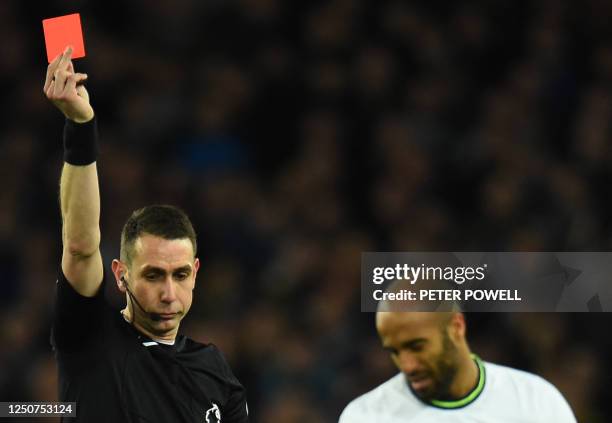 Referee David Coote gives a red card to Tottenham Hotspur's Brazilian midfielder Lucas Moura during the English Premier League football match between...