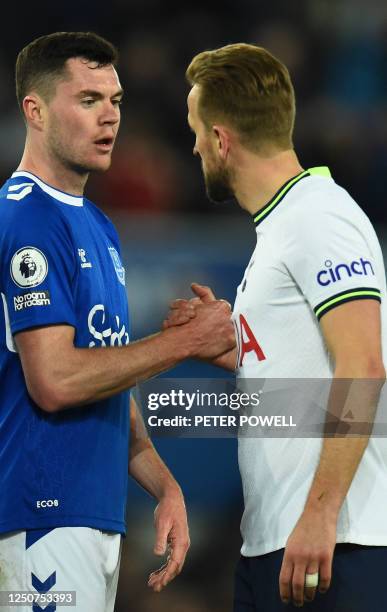 Everton's English defender Michael Keane and Tottenham Hotspur's English striker Harry Kane congratulate each other at the end of the English Premier...