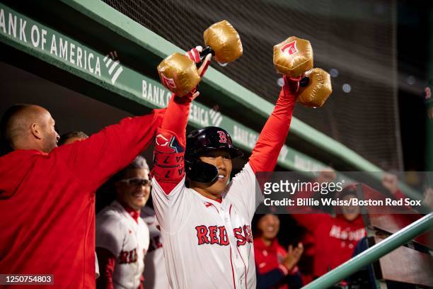 Masataka Yoshida of the Boston Red Sox reacts as he lifts inflatable weights after hitting a two run home run during the first inning of a game...