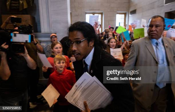 Democratic state Rep. Justin Jones enters the house chamber ahead of session as protesters chant demanding action for gun reform laws in the state at...