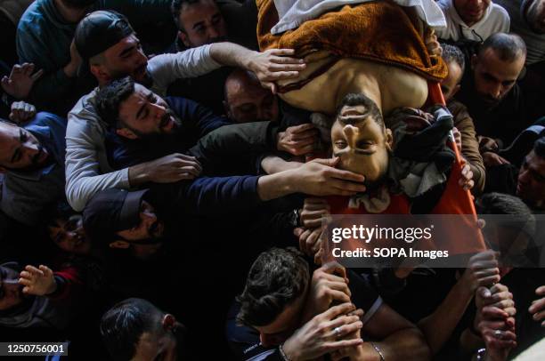 Relatives bid farewell to the body of one of the two Palestinians killed by the Israeli army, during their funeral in the city of Nablus, north of...