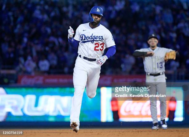 Jason Heyward of the Los Angeles Dodgers runs the base celebrating his two-run homer run to score Miguel Vargas against relief pitcher Jake Bird of...