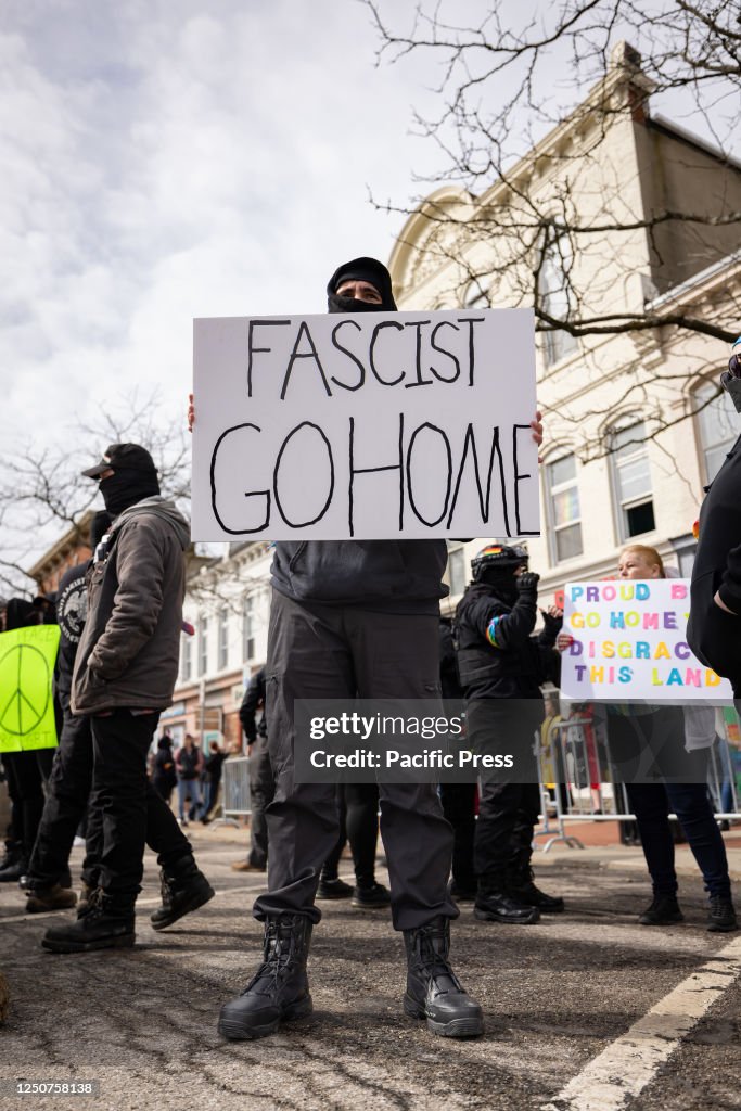 An anti-fascist counter-protester holds a sign outside the...
