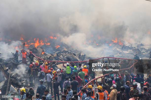 Firefighters run out of water as they try to douse a fire that broke out in a clothing market in Dhaka, Bangladesh on April 4, 2023.