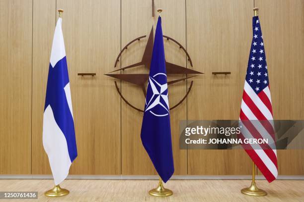 Photo shows Finnish, Nato and US flags during a NATO foreign ministers' meeting at the Alliance's headquarters in Brussels, on April 4, 2023. -...