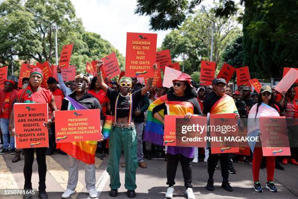Economic Freedom Fighters leader Julius Malema looks on as Ugandas queer activist Papa De raises a fist while picketing with others against the...