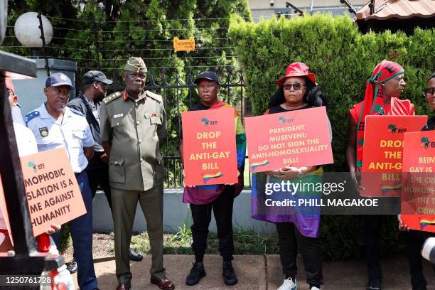 Economic Freedom Fighters leader Julius Malema and Uganda High Commissions military advisor Major General Fred Tolit look on during a picket against...