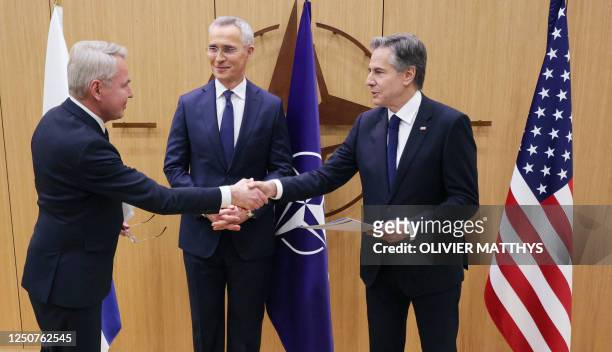Finnish Foreign Affairs Minister Pekka Haavisto shakes hands with US Secretary of State Antony Blinken, flanked by NATO Secretary-General Jens...