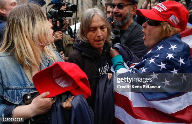 Trump supporters argues with an Anti-Trump protester after they removed an anti-Trump banner from her outside the Manhattan Criminal Courthouse on...