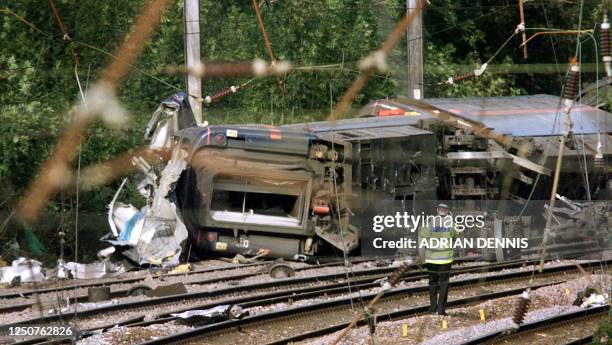 Policeman walks towards the carriages which overturned after the London to Leeds train derailed near Hatfield, thirty miles north of London, 17...