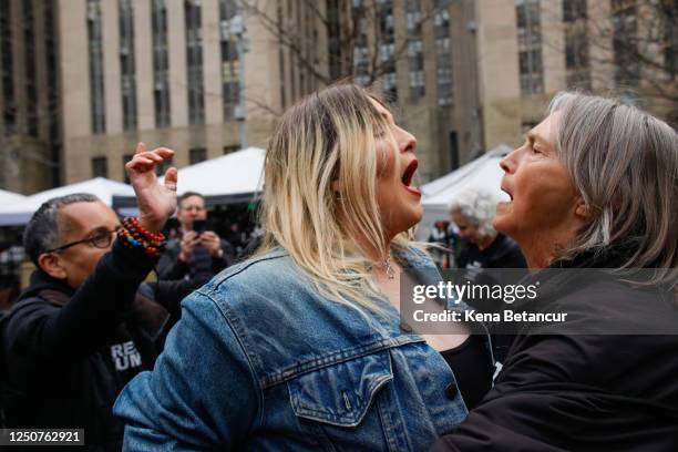 Trump supporter argues with an Anti-Trump protester after she removed an anti-Trump banner from her outside the Manhattan Criminal Courthouse on...