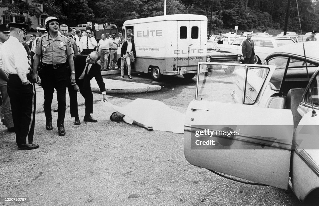 The body of slain nazi leader George Rockwell is seen near his car ...