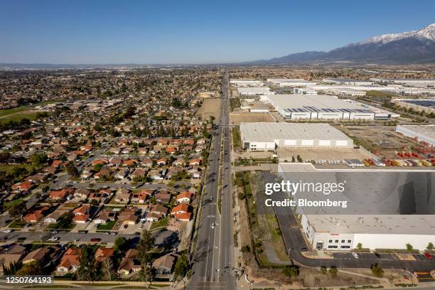 Warehouses next to home in Rialto, California, US, on Saturday, March 18, 2023. Southern California's Inland Empire, a notorious boom-and-bust...