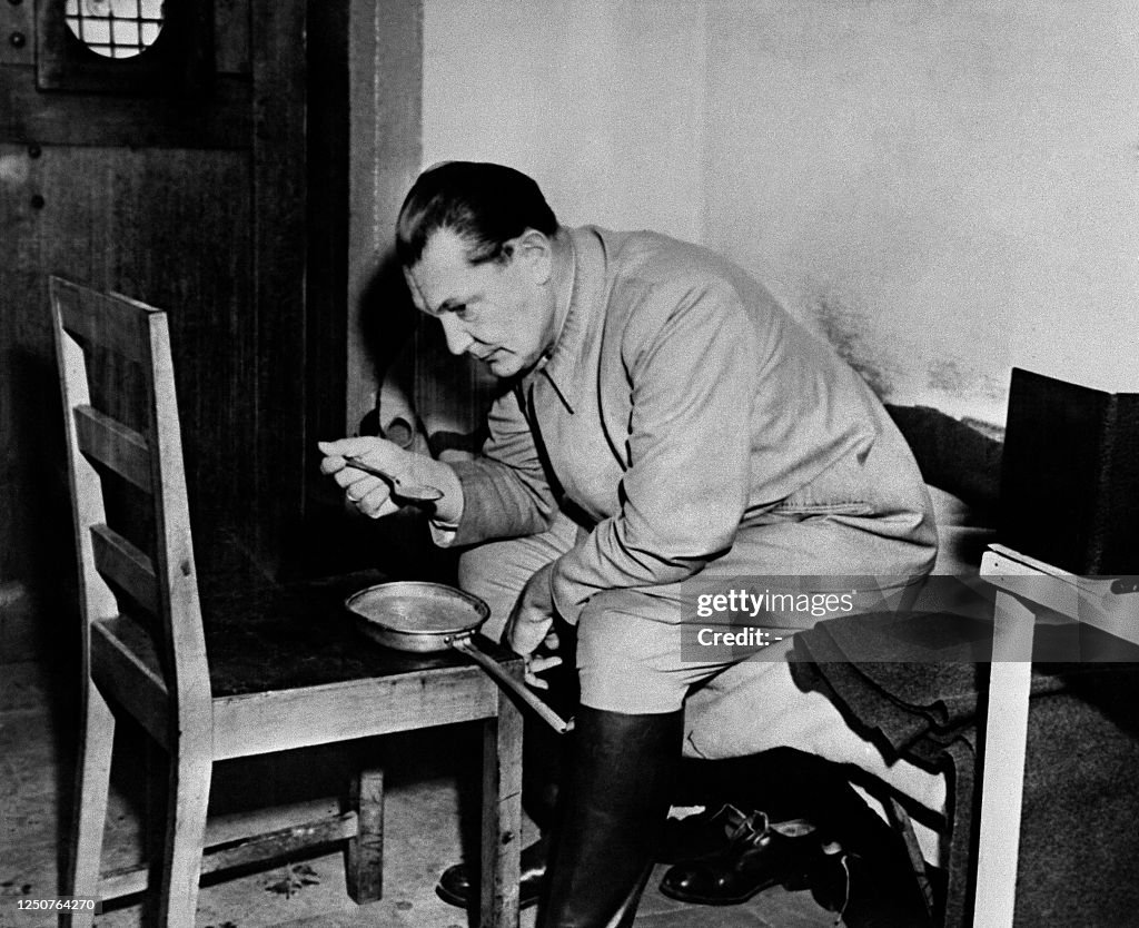 A photo dated circa December 1945 of Hermann Goering eating in his ...