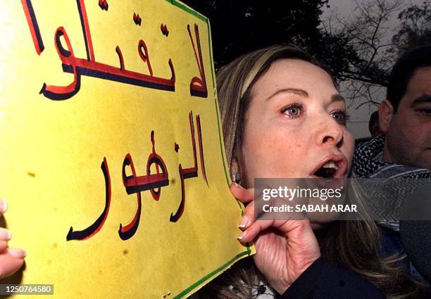 Syrian-born Egyptian actress Raghda carries a banner that reads "Do not kill the flowers" during a peaceful demonstration near the United Nations...