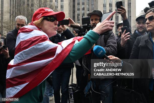 Supporter of former US President Donald Trump yells at members of the press outside the District Attorneys office in New York on April 4, 2023. -...
